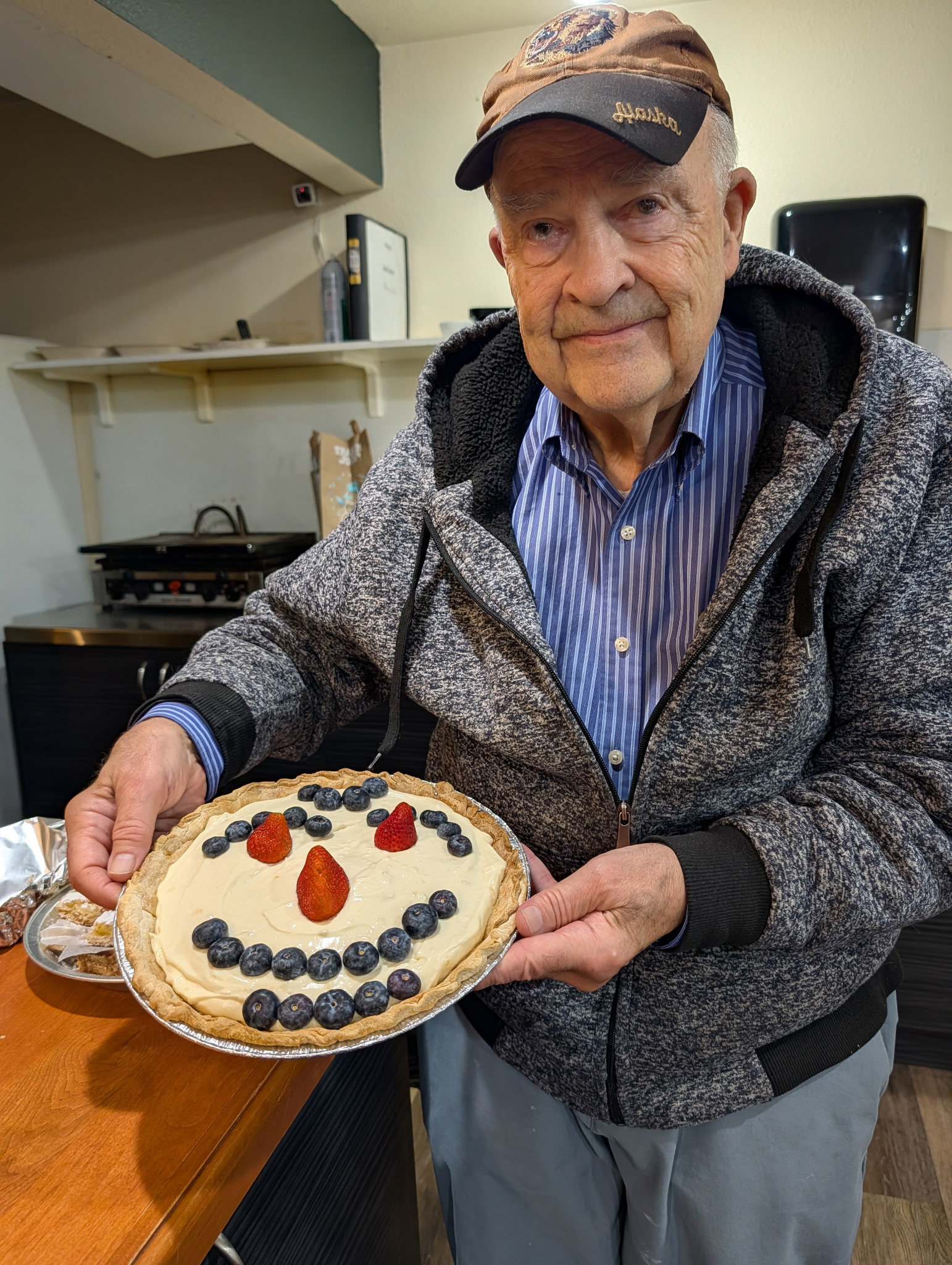 Thanksgiving-6 A volunteer shows off a dessert for the Thanksgiving meal.