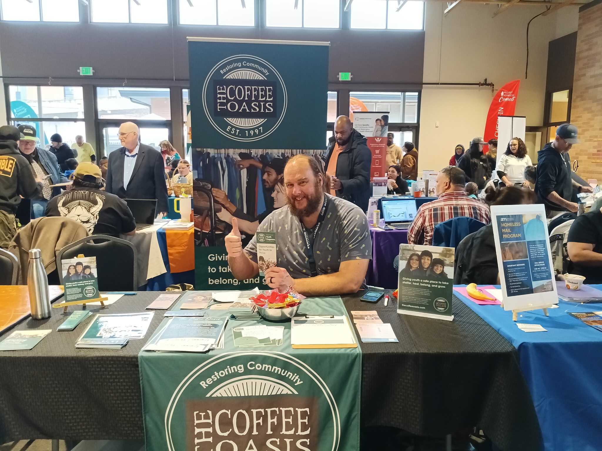 A staff member hosts a table at the annual Project Homeless Connect event.
